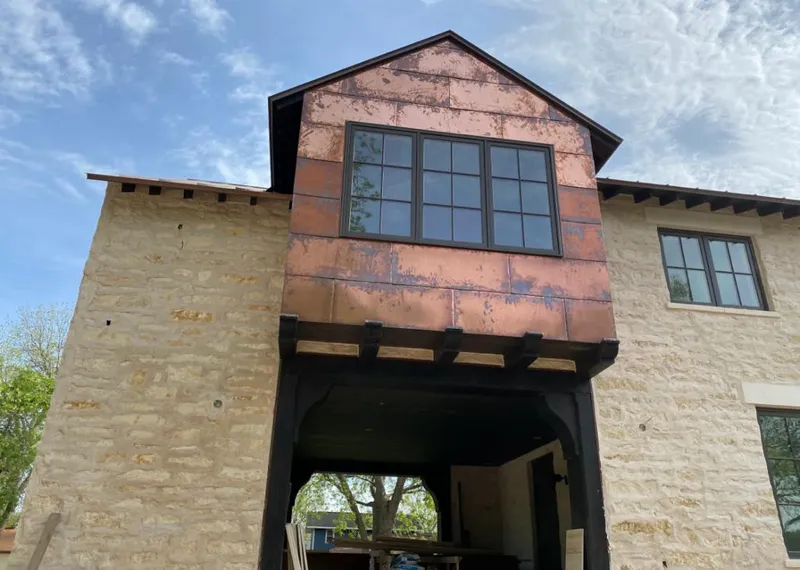 Copper metal panel facade on a stone building for Skylight Installation in Glenwood Springs